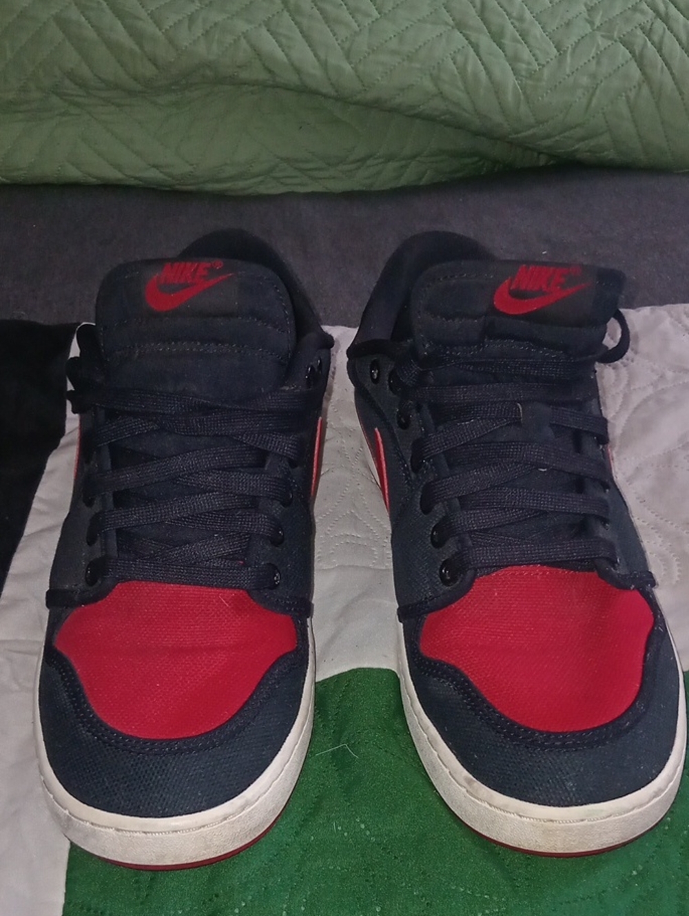 Nike Air Jordan 1 AJKO Low Bred sneakers in a black and varsity red colorway.
